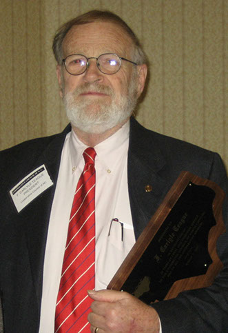 F. Carlyle Teague with his award